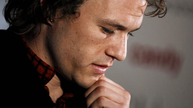 Heath Ledger hand on chin looking down