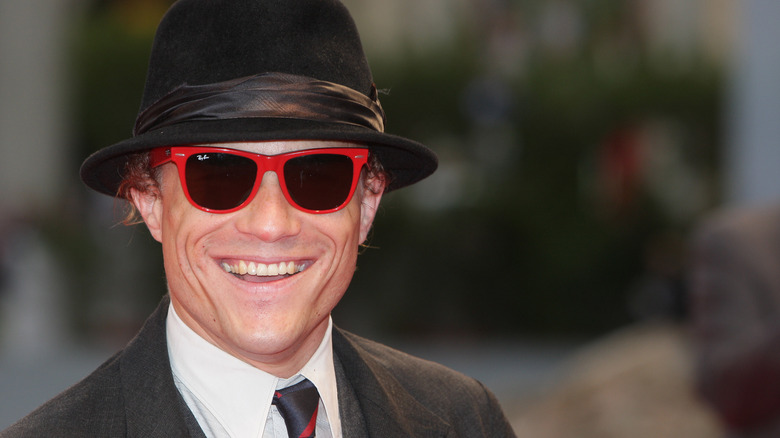 Heath Ledger trilby hat red sunglasses suit smiling