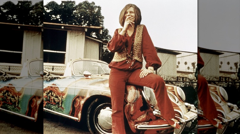 Janis Joplin posing with her psychedelic Porsche