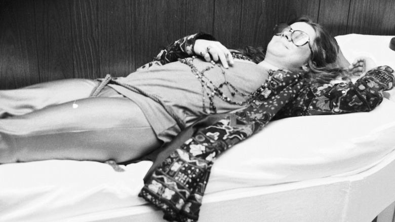 Janis Joplin reclining on a bed