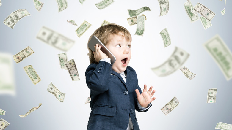 Kid with smartphone raining money