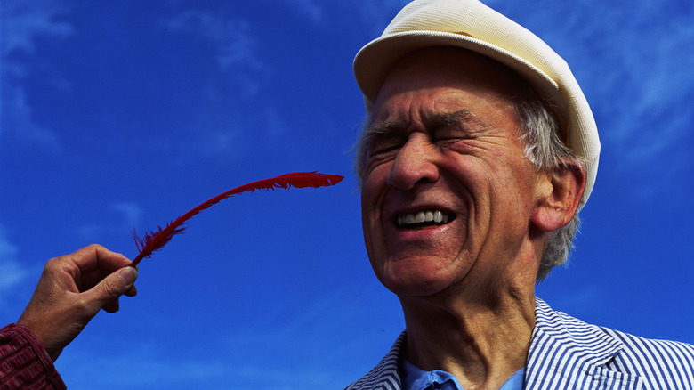 Man tickled by feather