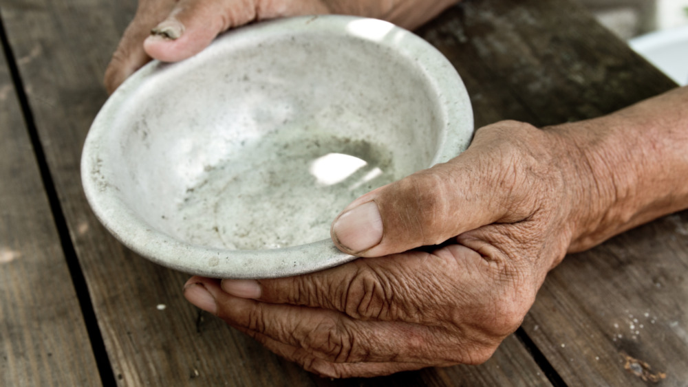 Hands hold an empty bowl