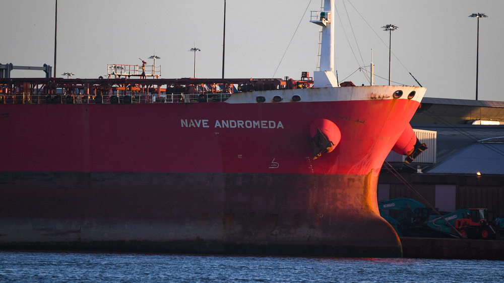 Large oil tanker sitting in a harbor 