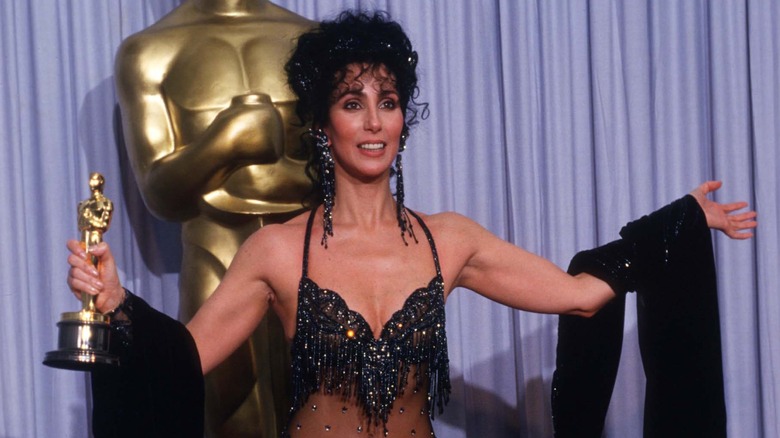 Cher holding her Oscar trophy