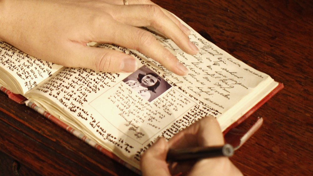Wax figure writing in Anne Frank's diary