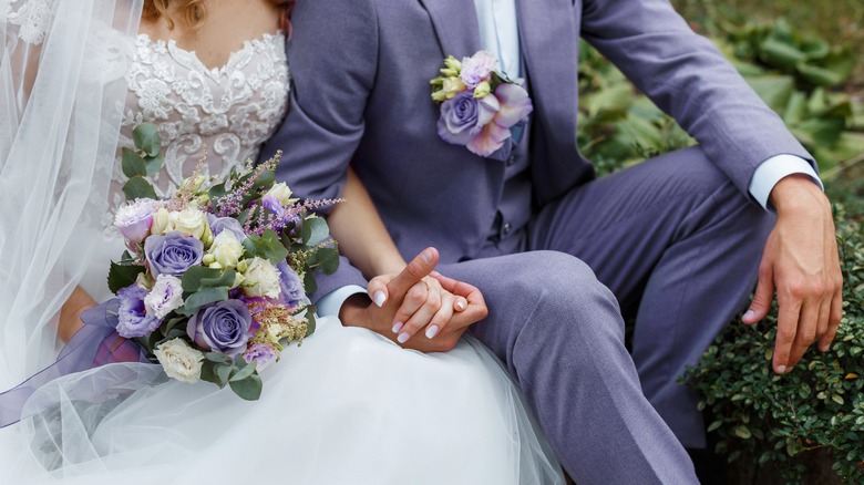 couple holding hands on wedding day