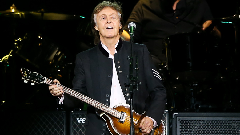 Paul McCartney playing bass on stage