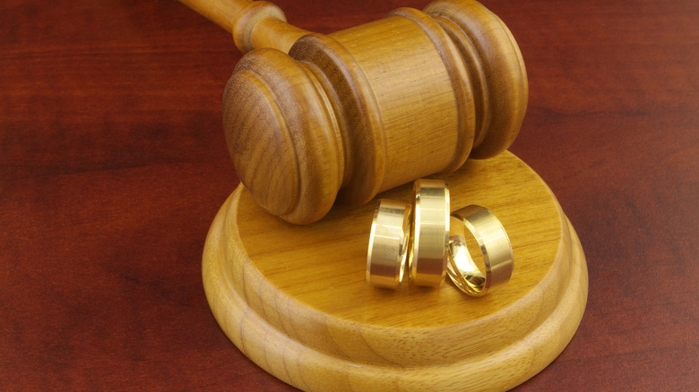 three wedding rings on a gavel