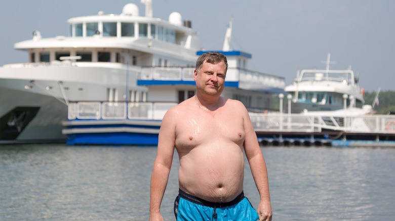 oligarch in front of his yacht