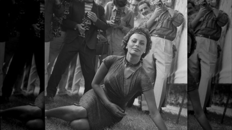 sophia loren being photographed on the grass