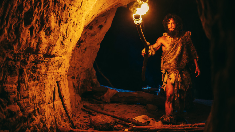 caveman holding torch