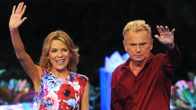 Vanna White and Pat Sajak waving