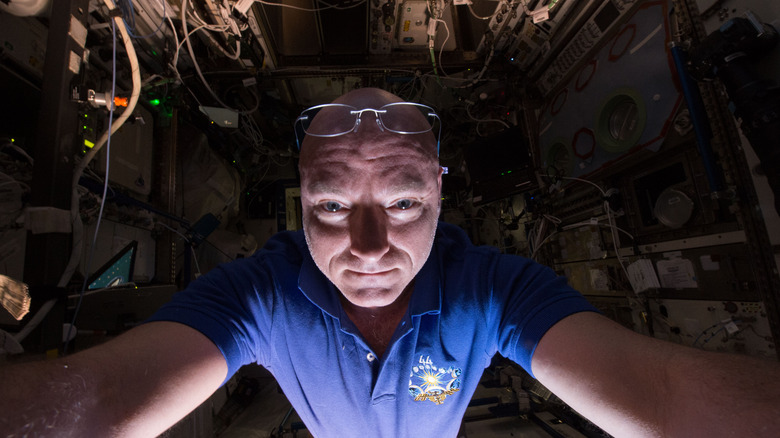 Astronaut Scott Kelly prepares for an experiment on the ISS