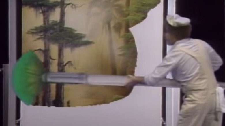 Bob Ross with a giant paintbrush