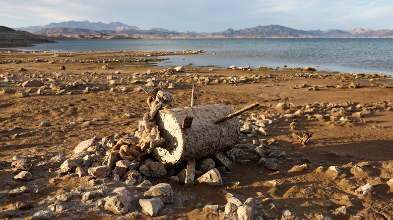 Rusted garbage on sandy shore