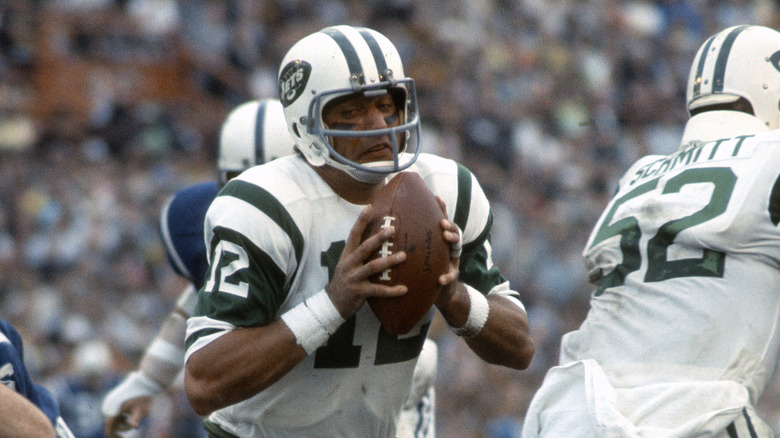 Joe Namath looks to pass