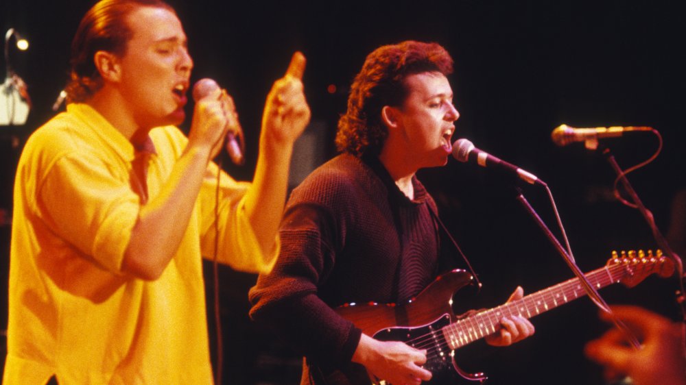 Curt Smith singing and Roland Orzabal playing guitar