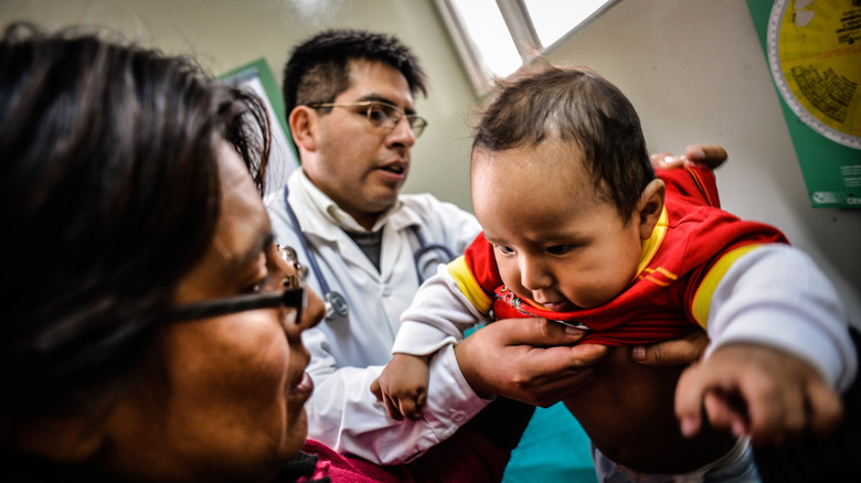 Doctor examining baby