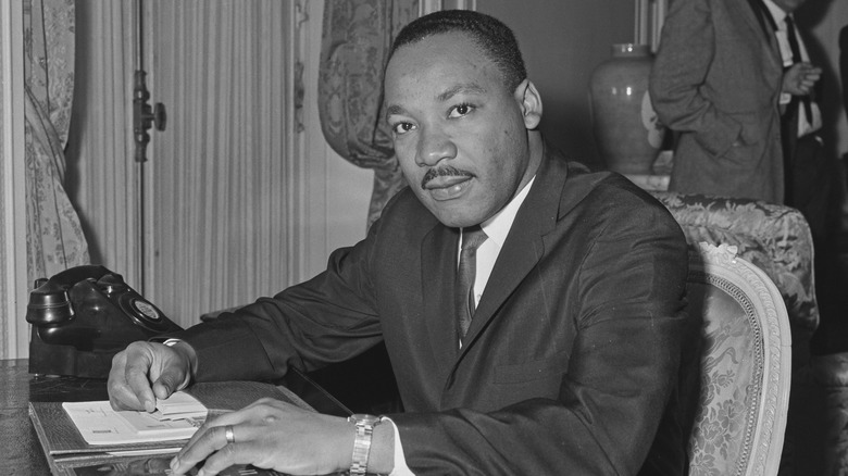 Martin Luther King Jr. sitting at desk