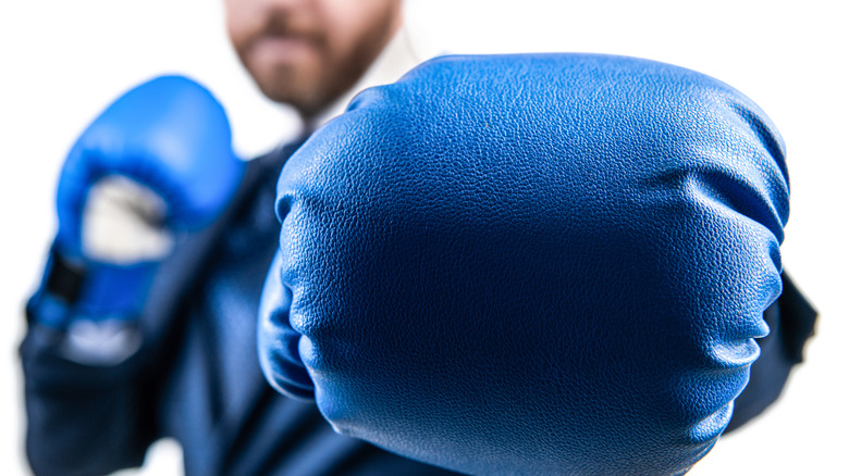 blue boxing glove punches screen
