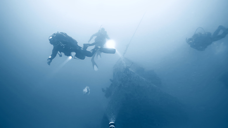 Divers searching underwater wreckage