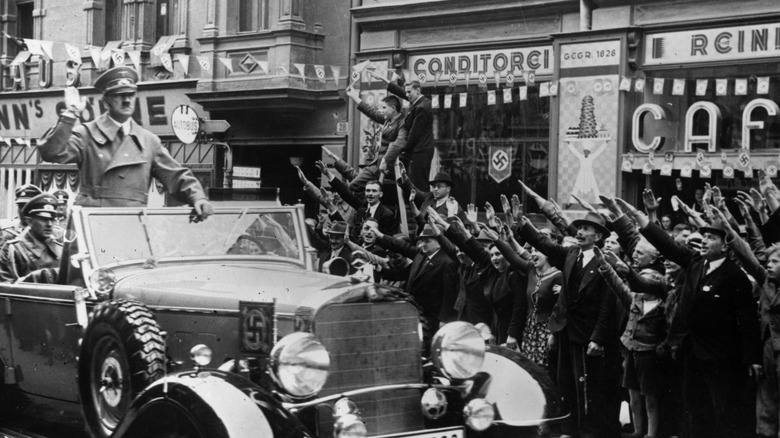 Adolf Hitler waving in car