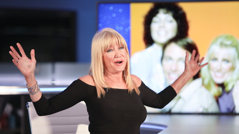 Suzanne Somers raises her arms