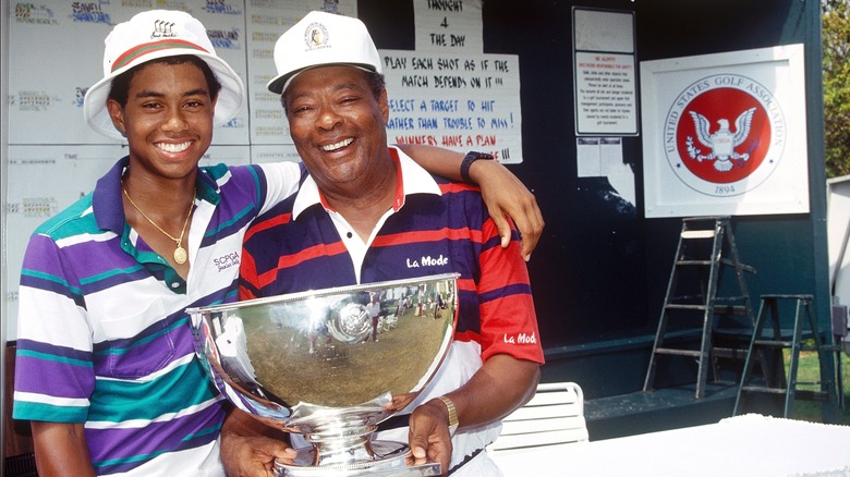 Tiger Woods aged 15 with his father Earl after winning Amateur trophy