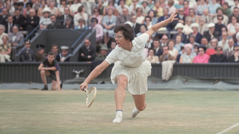 King hitting a shot at Wembledon, 1965