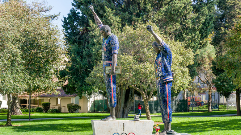 a statue honoring Smith and Carlos with hands raised