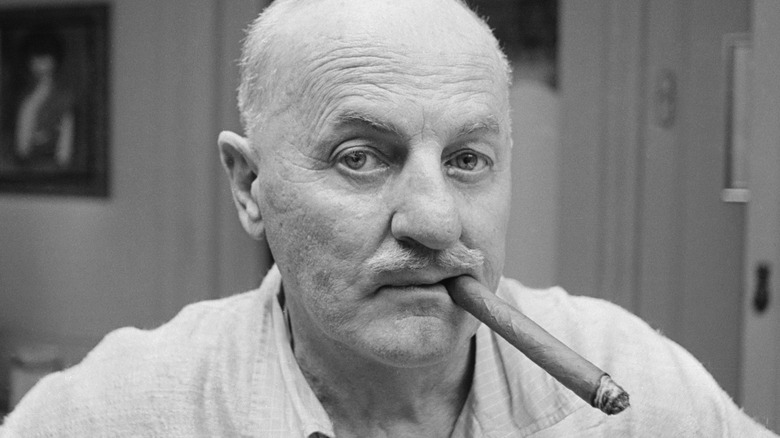 Fox chief Darryl Zanuck chomps on a cigar