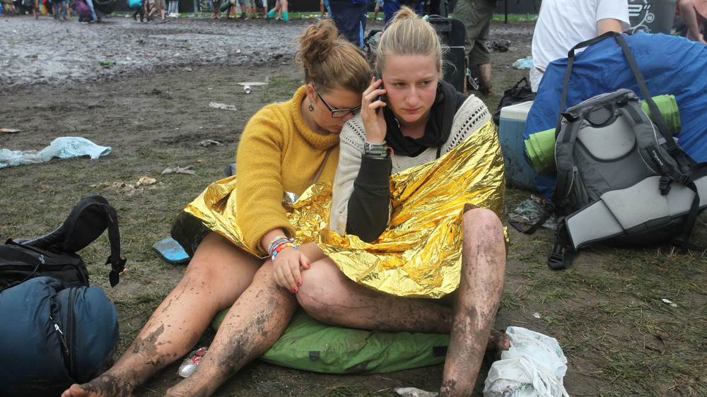 two women on ground debris muddy