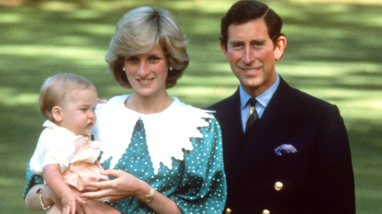 Prince Charles and Princess Diana hold up Prince William
