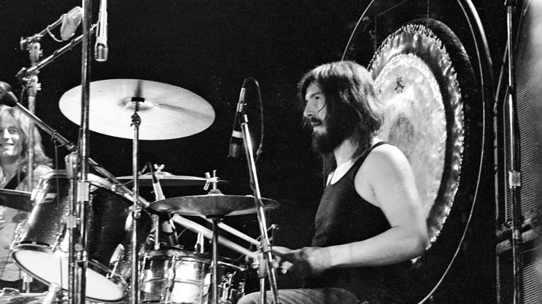 John Bonham at a drum kit with gong