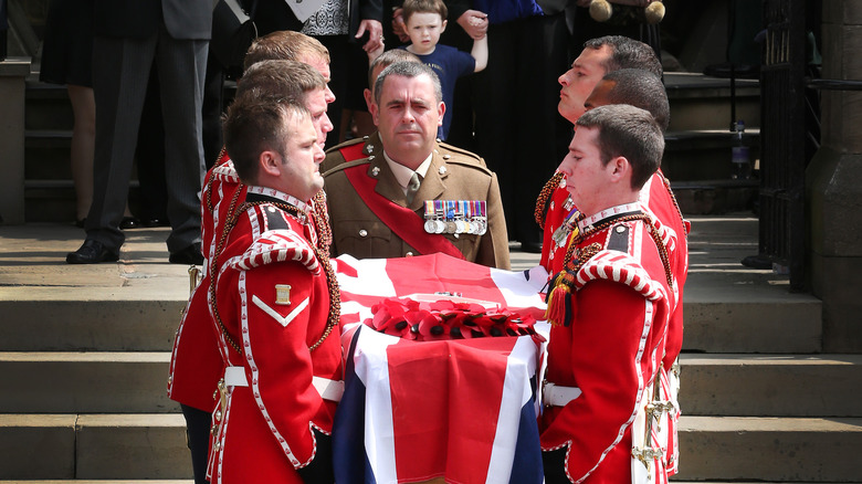 Lee Rigby's coffin is carried down stairs