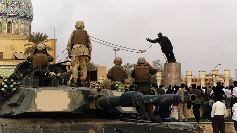 Troops watch as Saddam Hussein statue is torn down