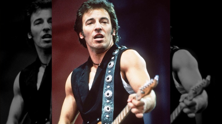 Bruce Springsteen on stage guitar performing