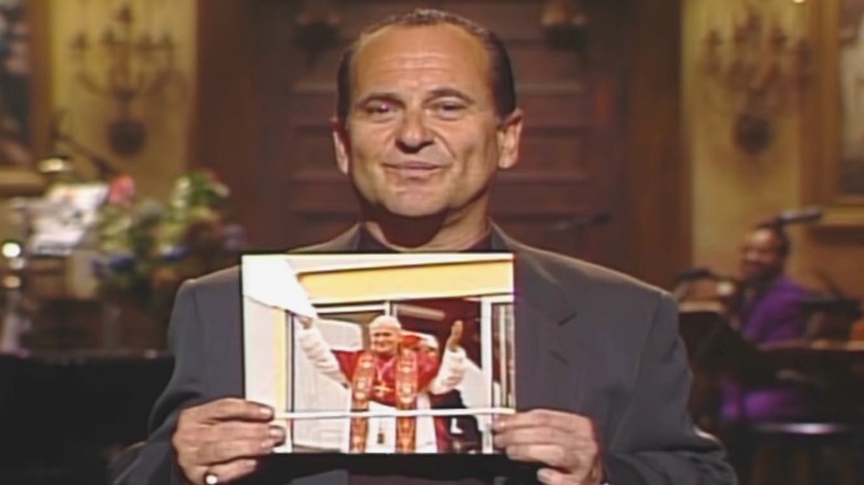 Joe Pesci holding picture pope onstage