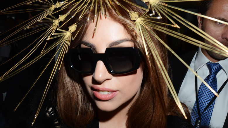 Lady Gaga in large gold fascinator