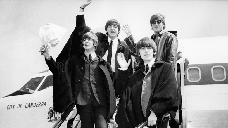 The Beatles disembarking a plane