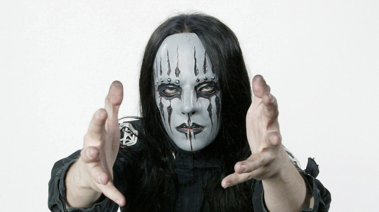 Slipknot's Joey Jordison with his hands out and posing for a photo