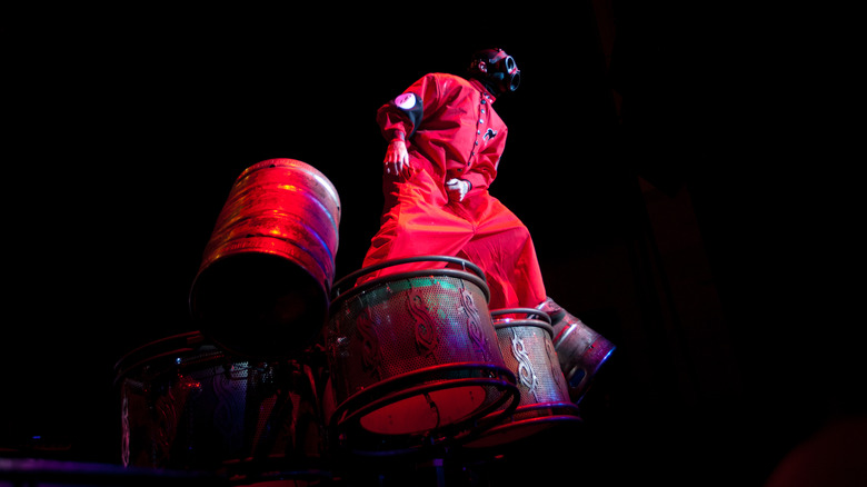 Slipknot's Sid Wilson standing on top of a drum set in 2012