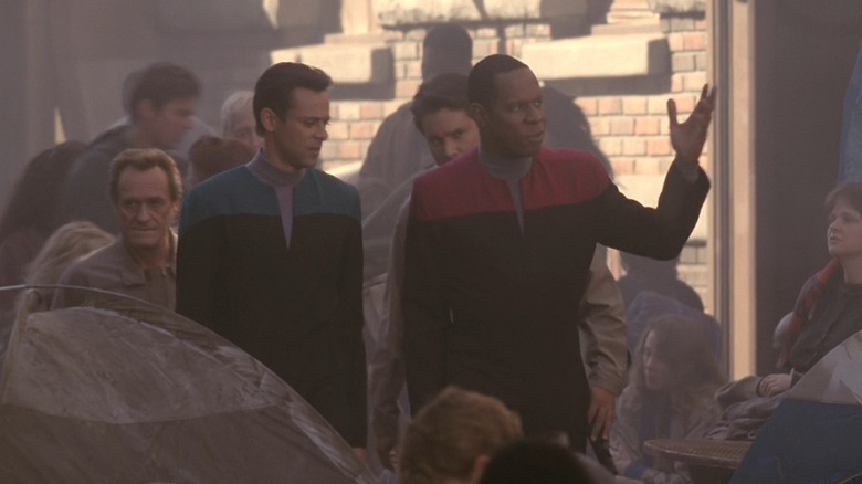 Bashir and Sisko walk through a sanctuary district