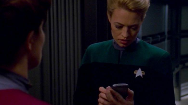 Seven Of Nine holds a tricorder