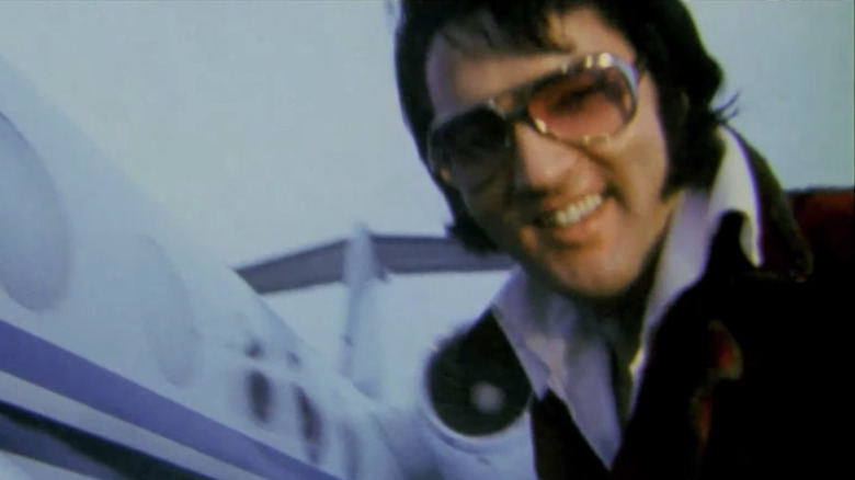 Elvis getting on a plane to tour