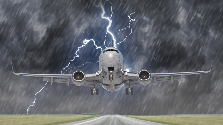 Airline jet landing in a thunderstorm with heavy rain