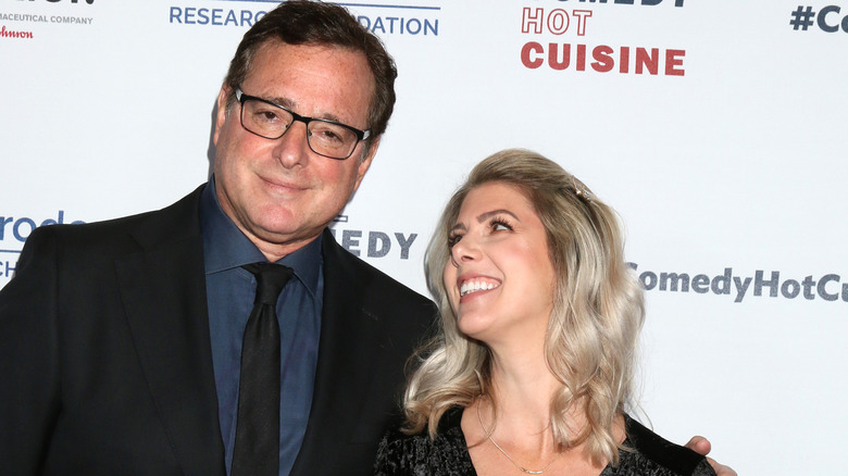 Bob Saget with his wife Kelly Rizzo smiling