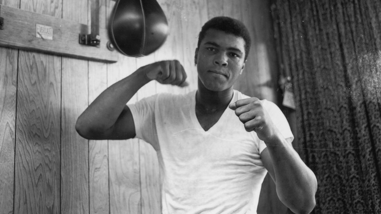 Muhammad Ali fists raised punch bag
