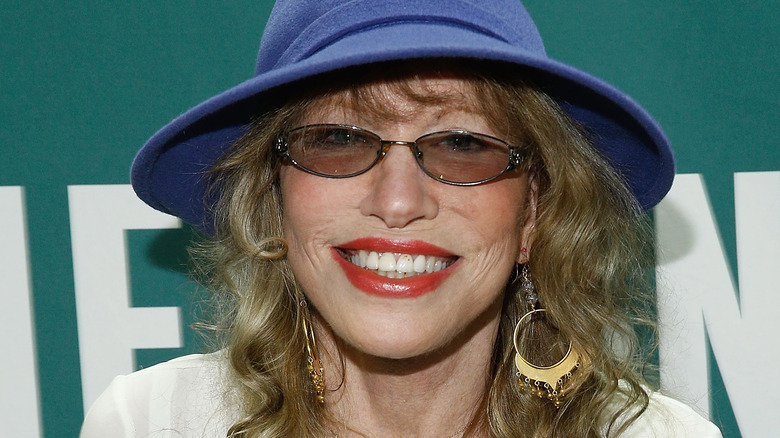 Carly Simon blue hat smiling